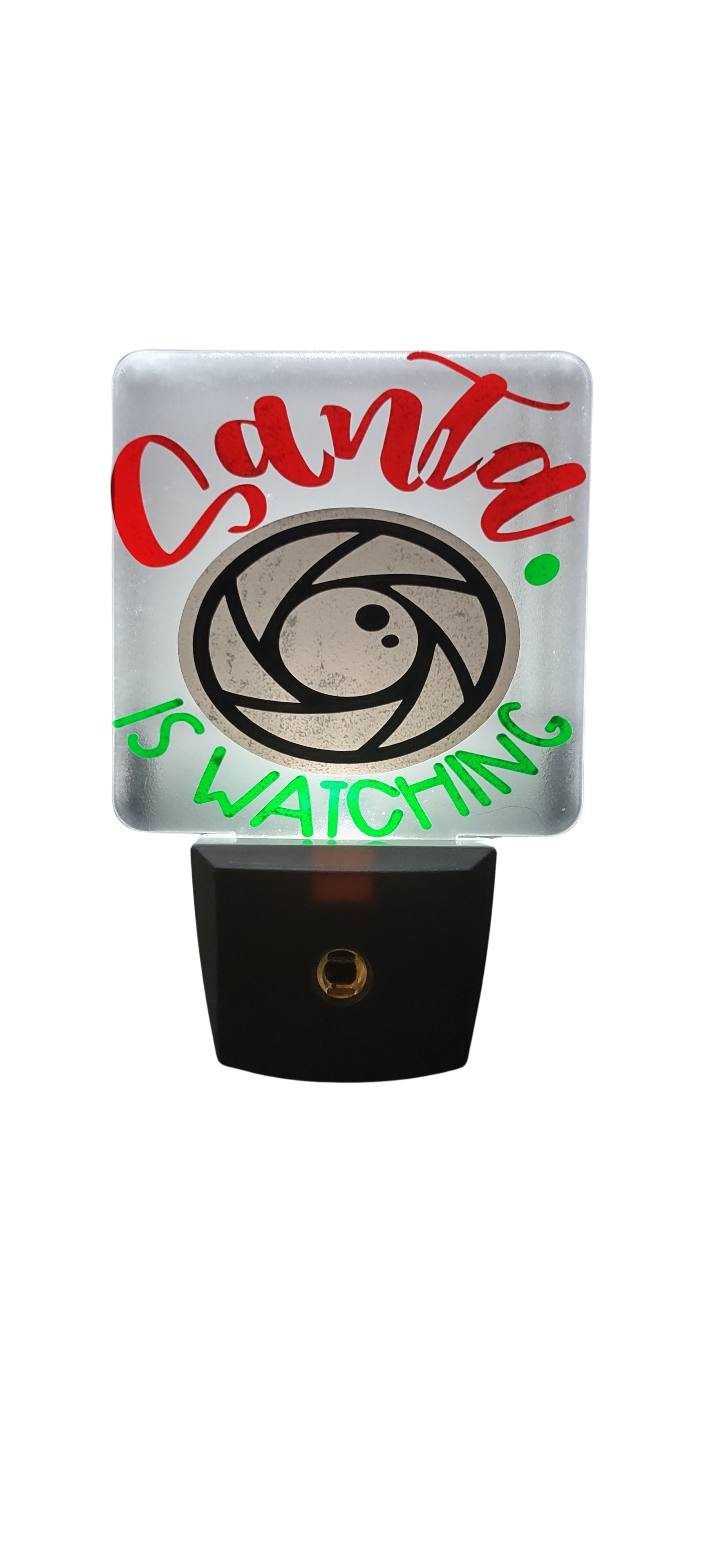Decorative night light with 'Santa is watching' text and camera symbol