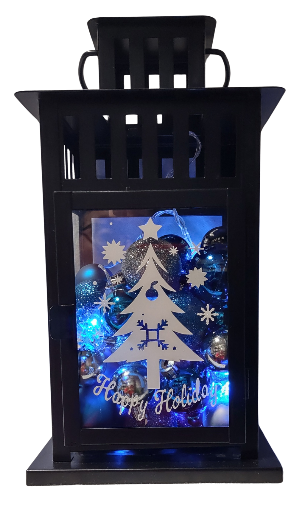 Decorative lantern with Christmas tree design and 'Happy Holidays' text