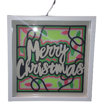 Decorative sign with 'Merry Christmas' text on a colorful background, framed in white.