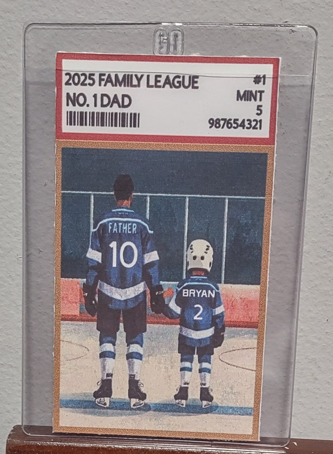 Collectible card featuring a father and son on an ice rink with '2025 Family League' text.
